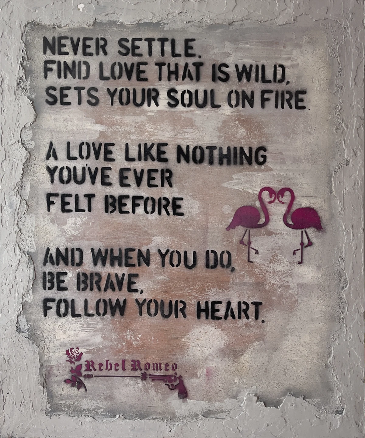 Never Settle: black stencilled lettering, magenta flamingos and the complete original plaster border, shown in a black float frame