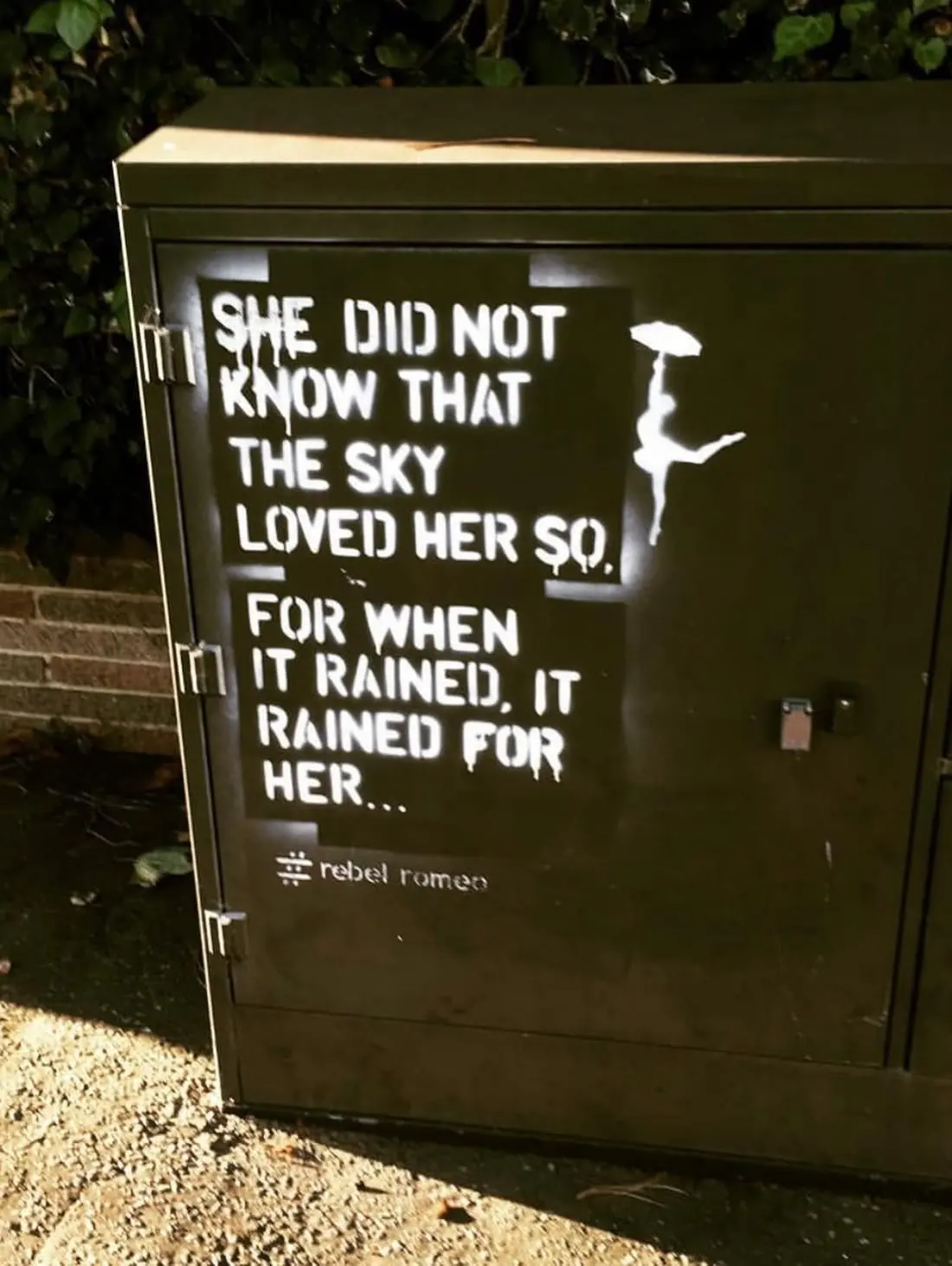 The original She Did Not Know stencil on a green electrical box, Worthing, 2017, in golden evening light