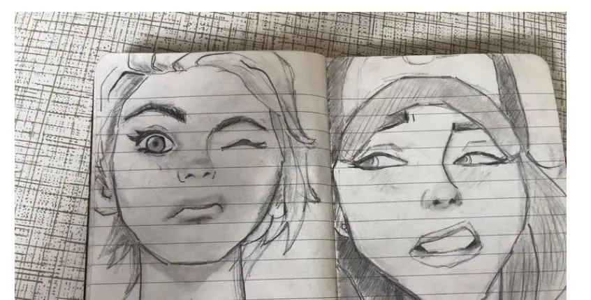 Open sketchbook with two pencil portrait studies of women's faces